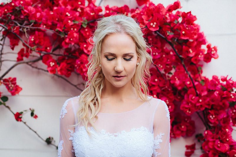 Bride In From Of Red Flowers